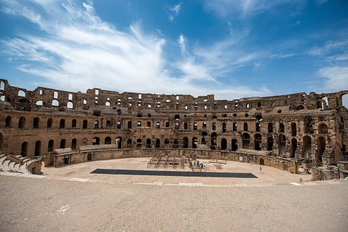 El Jem, Tunisia - June 17, 2019: Amphitheatre of El Jem in Tunisia. Amphitheatre is in the modern-day city of El Djem, Tunisia, formerly Thysdrus in the Roman province of Africa. It is listed by UNESCO since 1979 as a World Heritage Site