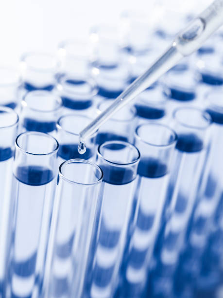 istock Droplet Falling from Pipette into Test Tube. 1558042581