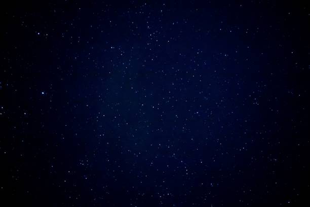 istock Calm night sky dotted with white stars 1558047975