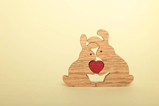 Rabbits with heart on yellow background