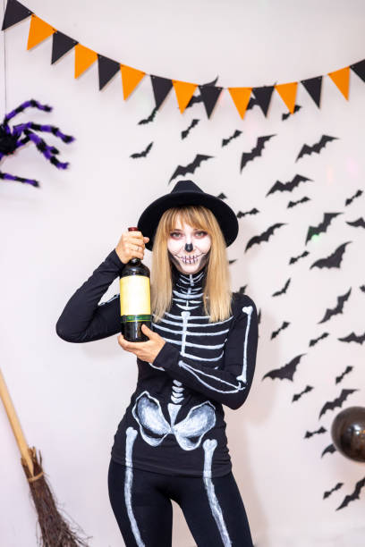 istock Costumed Halloween. Young woman in skeleton costume 1558071252