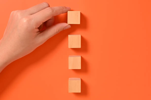 istock Hand with wooden cubes mock up on abstract background, Copy space, Wooden blocks with copy space for text or symbols, Background with copy space 1558077659