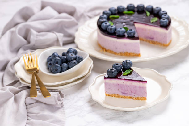istock Blueberry cheesecake with berries and mint leaves on top 1558079312