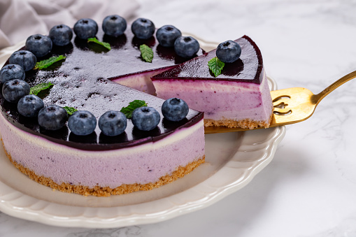 Blueberry cheesecake with berries and mint leaves on top