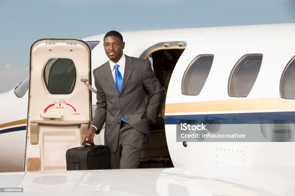 Uomo d'affari in piedi fuori dell'Aereo aziendale - Foto stock royalty-free di Aereo privato