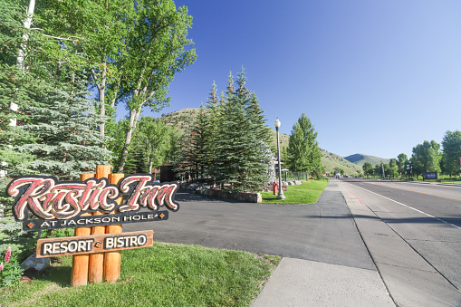 The entrance sign to The Rustic Inn Creekside Resort & Spa on North Cache Street at Jackson Hole in Teton County, Wyoming. This is a commercial venue.