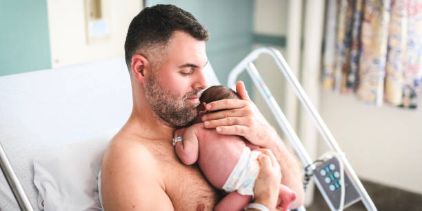 istock New born baby boy resting in father arms 1558118029