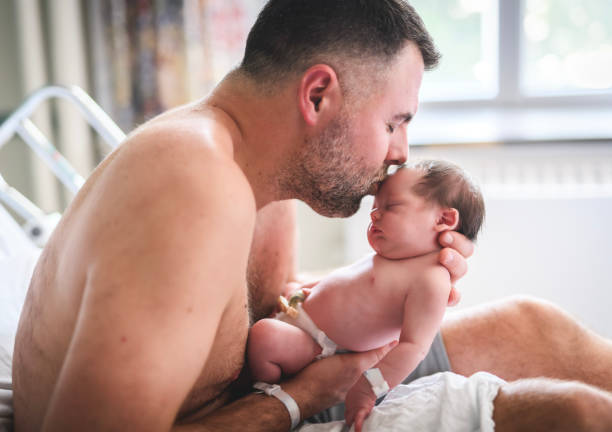 istock New born baby boy resting in father arms 1558118041