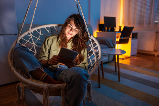 istock Woman relaxing at home reading an e-book 1558123571