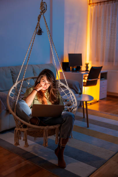 istock Woman working remotely from home late at night using laptop computer 1558125753