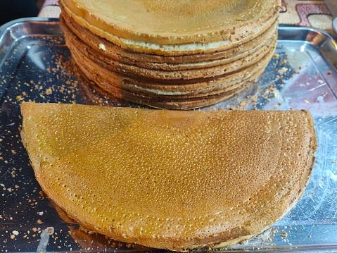 Focus scene on street food display - crepe with grounded peanut filling at night market