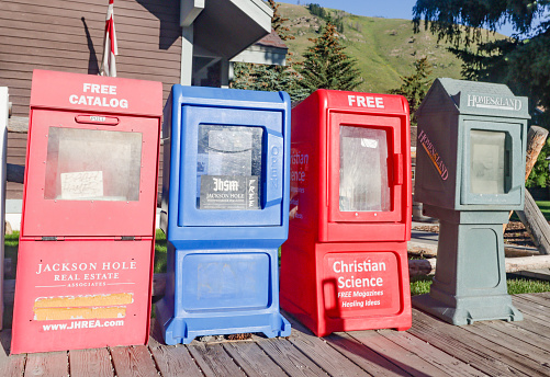 Newspaper Vending Machines at Jackson (Jackson Hole) in Teton County, Wyoming, with several newspaper brands visible.