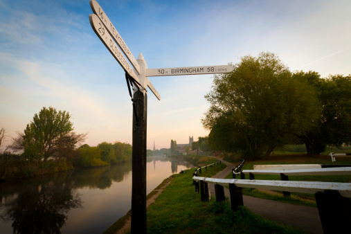 The sign which stands at the junction of the Worcester-Birmingham Canal with the River Severn at Worcester, pictured early on a summer's morning