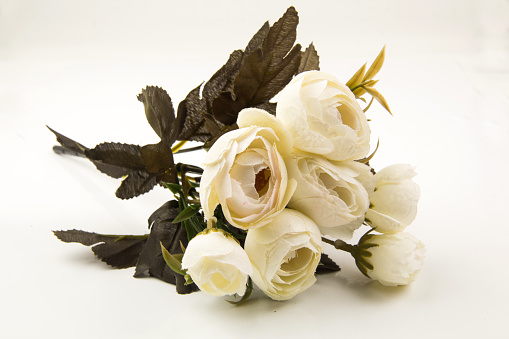 Bouquet of artificial flowers in a white table