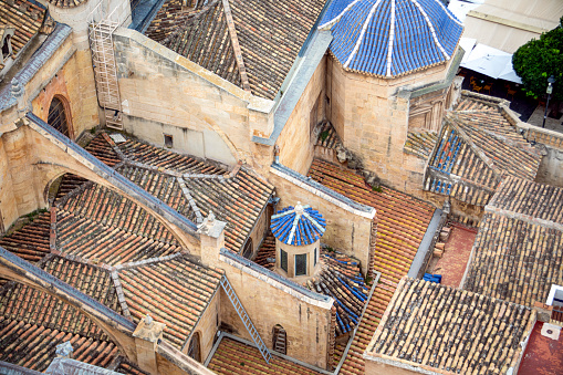 View from above of the architectural details and the cathedral of Santa Maria de Murcia, Spain with its characteristic blue tiles