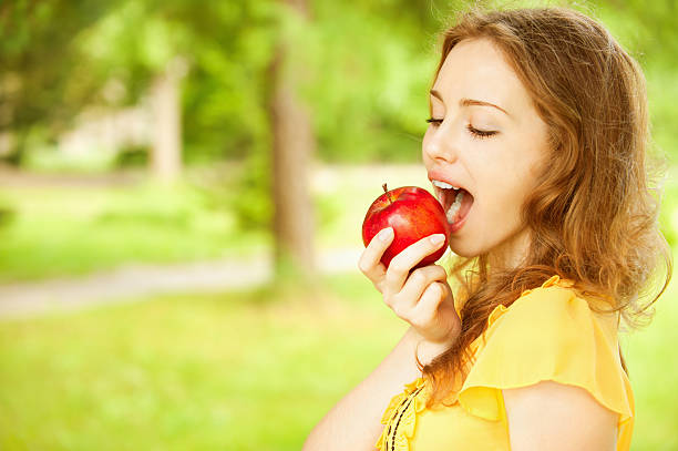 istock Girl with red apple 155820464
