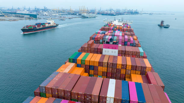 istock Stern of large cargo container ship import export container box on the ocean sea on blue sky back ground concept transportation logistic and service to customer and supply change 1558211301