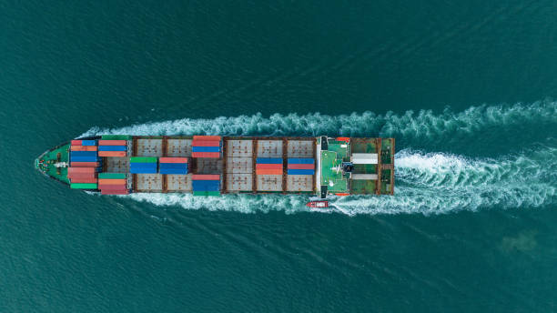 istock aerial top view Cargo Ship carrying container and running for export goods from cargo yard port to other ocean concept freight shipping ship 1558211317