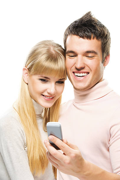 istock young couple looking at mobile telephone 155822346