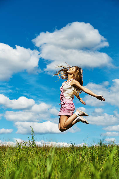 young woman high jumps stock photo