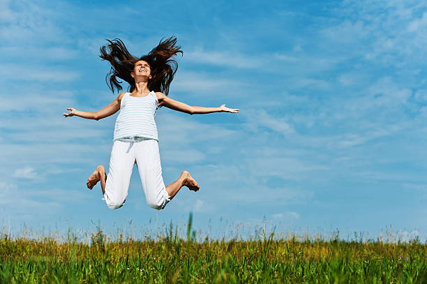 istock young woman jumping 155823883