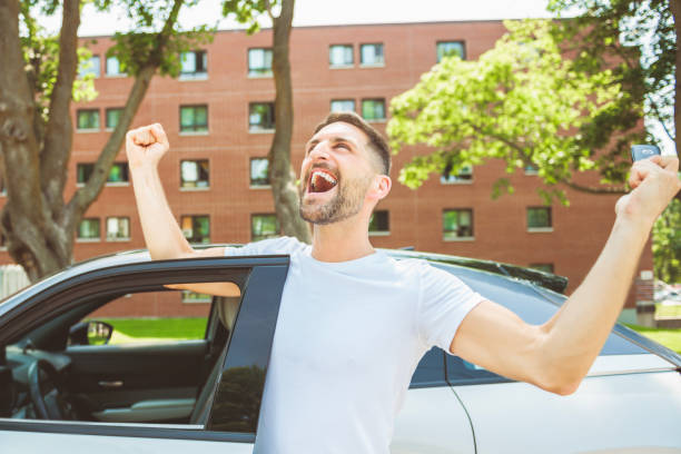 istock Mid adult man feeling comfortable with his new car. 1558240413