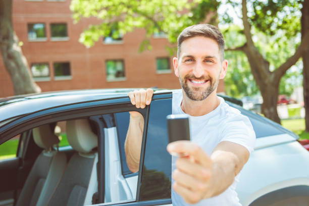 istock Mid adult man feeling comfortable with his new car. 1558240697
