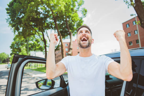 istock Mid adult man feeling comfortable with his new car. 1558240780