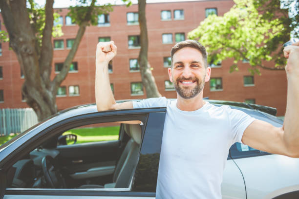 istock Mid adult man feeling comfortable with his new car. 1558240788