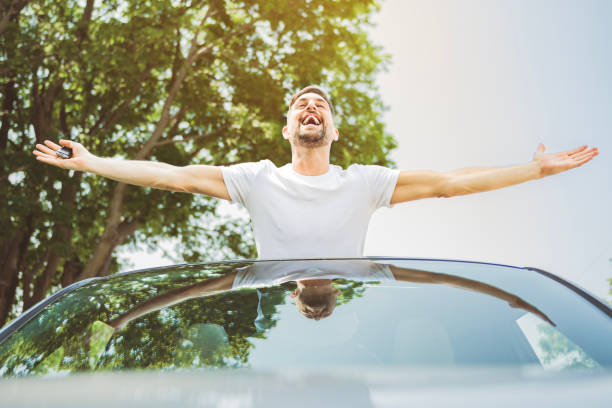 istock Mid adult man feeling comfortable with his new car. 1558240804