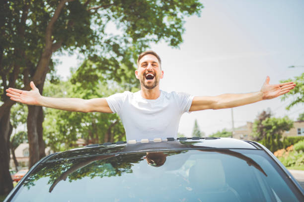 istock Mid adult man feeling comfortable with his new car. 1558240806