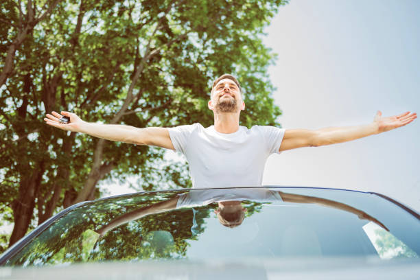 istock Mid adult man feeling comfortable with his new car. 1558240810