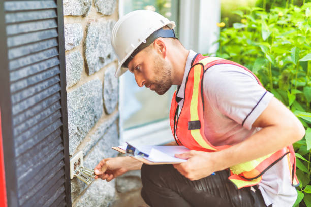 istock Man with a white hard hat holding a clipboard, inspect house 1558241375