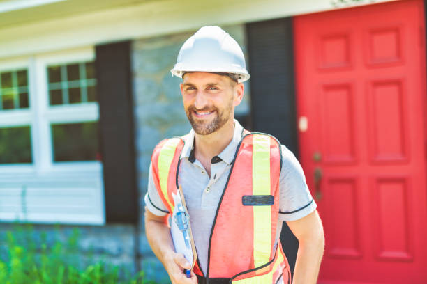 istock Man with a white hard hat holding a clipboard, inspect house 1558241381