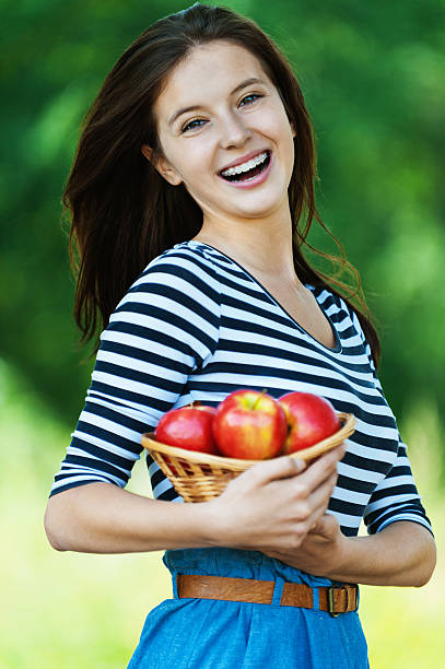istock cheerful woman basket apples 155824155