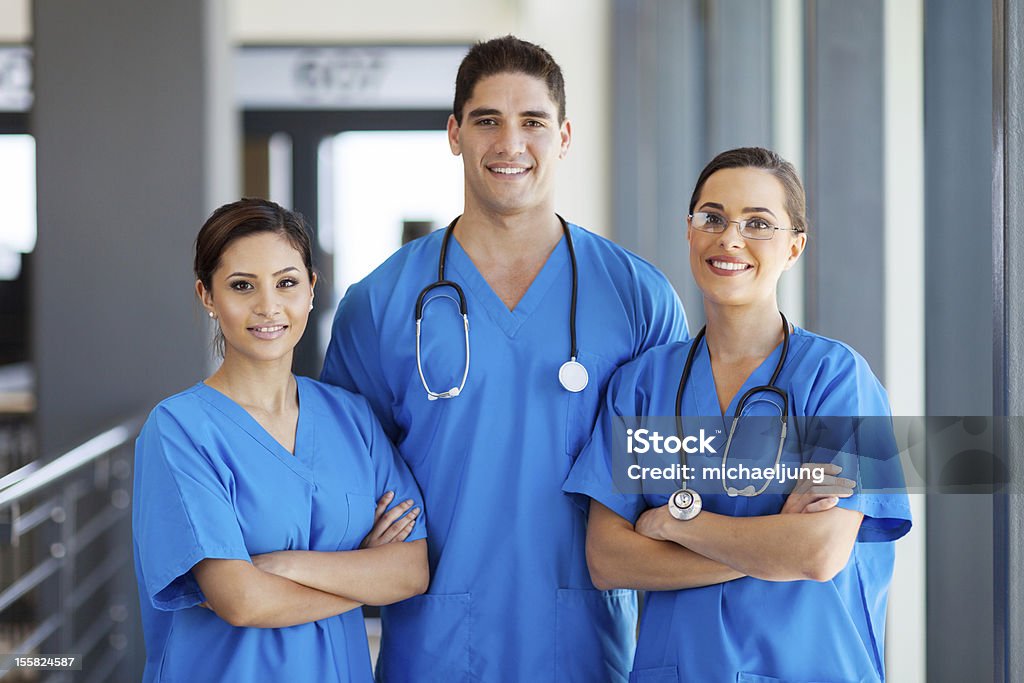 young hospital workers in scrubs group of young hospital workers in scrubs Nurse Stock Photo