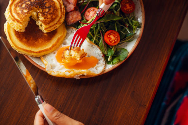 istock Breakfast Pancakes with Fried Eggs, Bacon and Salad 1558254379