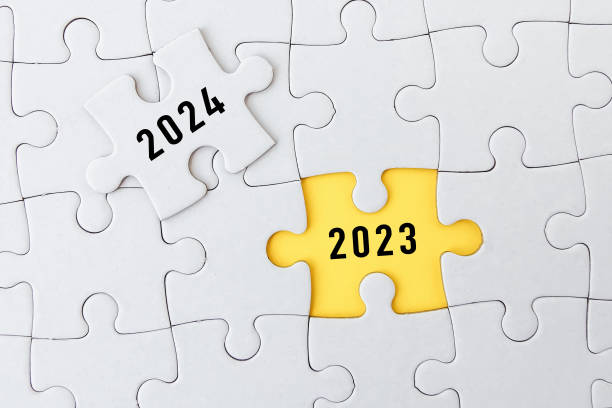 istock 2023, 2024 on puzzle background, business concept. 1558254792