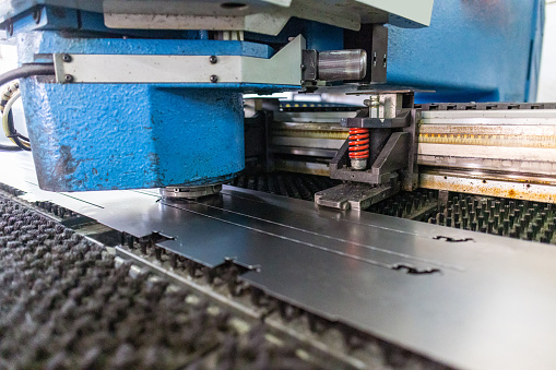 Stock photo of a laser cutting machine in an industrial factory setting.