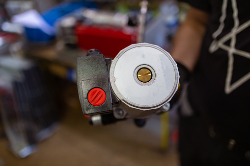 Close-up of an employee operating a machine.