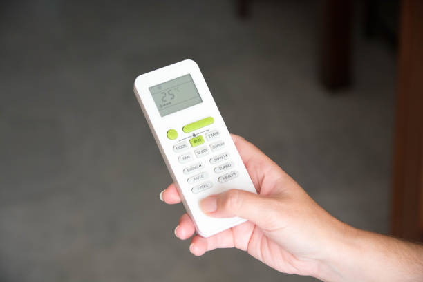 istock Hand holding air conditioning and heating knob with comfortable temperature. 1558271180