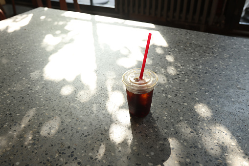 Take away iced coffee on table in coffee shop