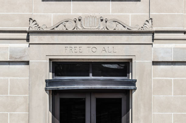 istock FREE TO ALL text in sandstone library building facade. 1558288629