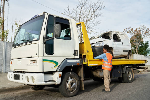 istock Tow truck operator securing vehicle on flatbed 1558296645