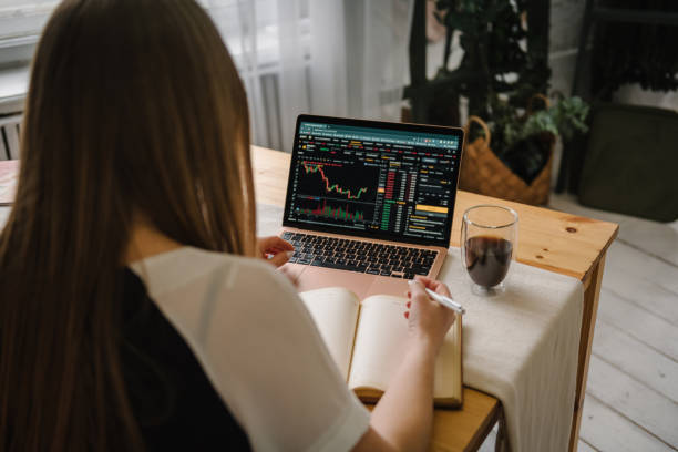 istock Back top view. Freelancer works on laptop computer with graphs, diagrams on screen. Marketing. Bull market trend. Cryptocurrency. Falling bitcoin stock. Chart shows a strong fall in price of bitcoin. 1558310815