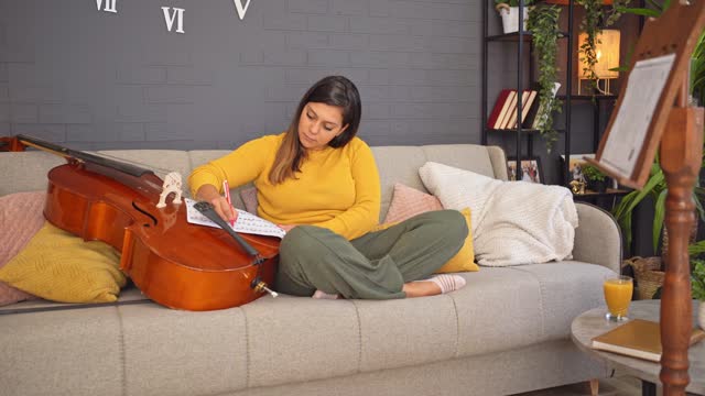 Young woman composing music at home