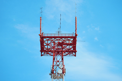 Communication tower with antennas against blue sky. Mast 5g. Background.