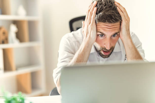 istock Mature business man using laptop computer in office look like frustrated 1558326336