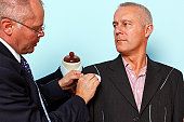Bespoke suit adjustment by a tailor