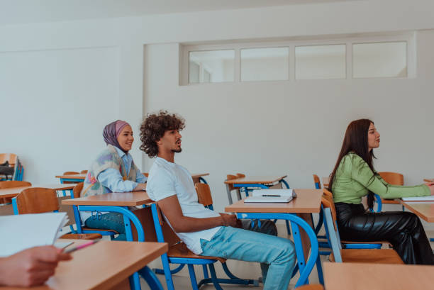 istock A diverse group of students is attentively listening, actively participating, and embracing modern education in a dynamic classroom setting, fostering collaboration and stimulating creativity. 1558346355